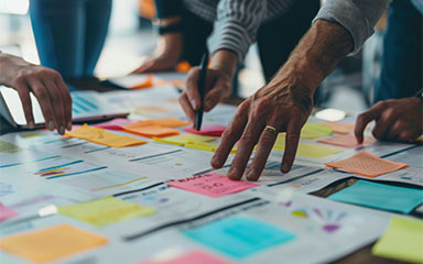 Planning workshop with sticky notes and charts for digital therapy launch.