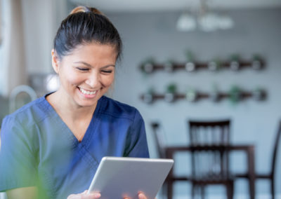 Smiling nurse using a tablet